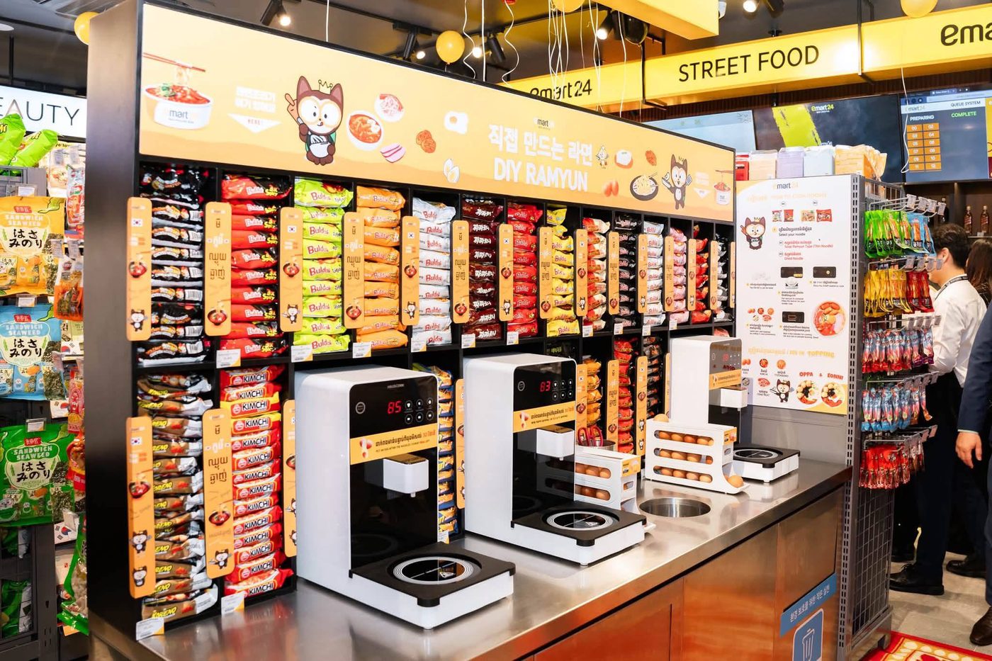 The DIY ramyun wall with instant noodle packets, hot water machines and an egg rack